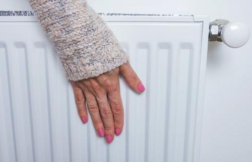 Our sense of touch is actually lots of different senses rolled into one. Image shows woman's hand placed on a heater. Yevhen Prozhyrko/Shutterstock
